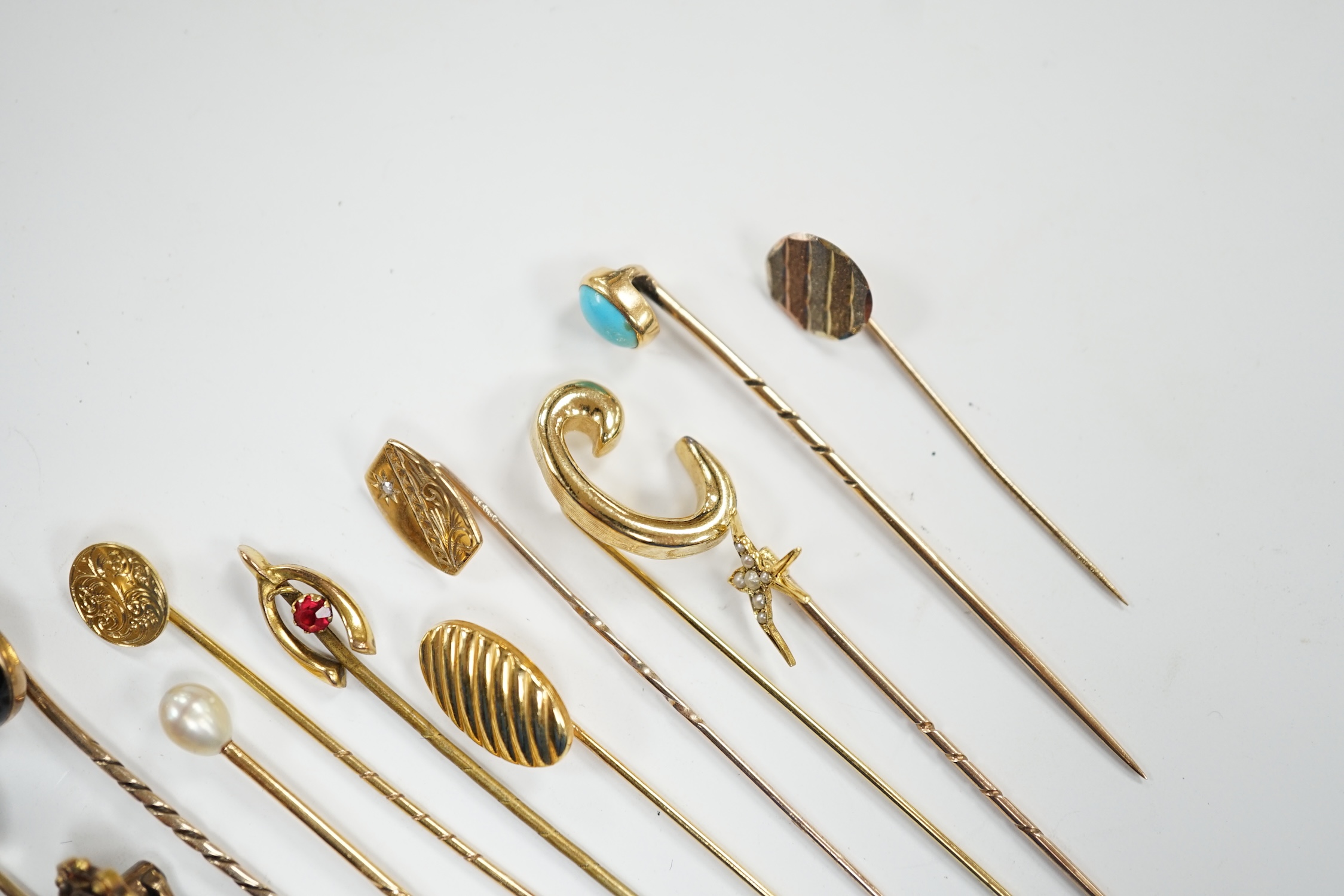 Fifteen assorted mainly early 20th century yellow metal and gem set stick pins, including diamond, seed pearl and banded agate, gross weight 23.1 grams.